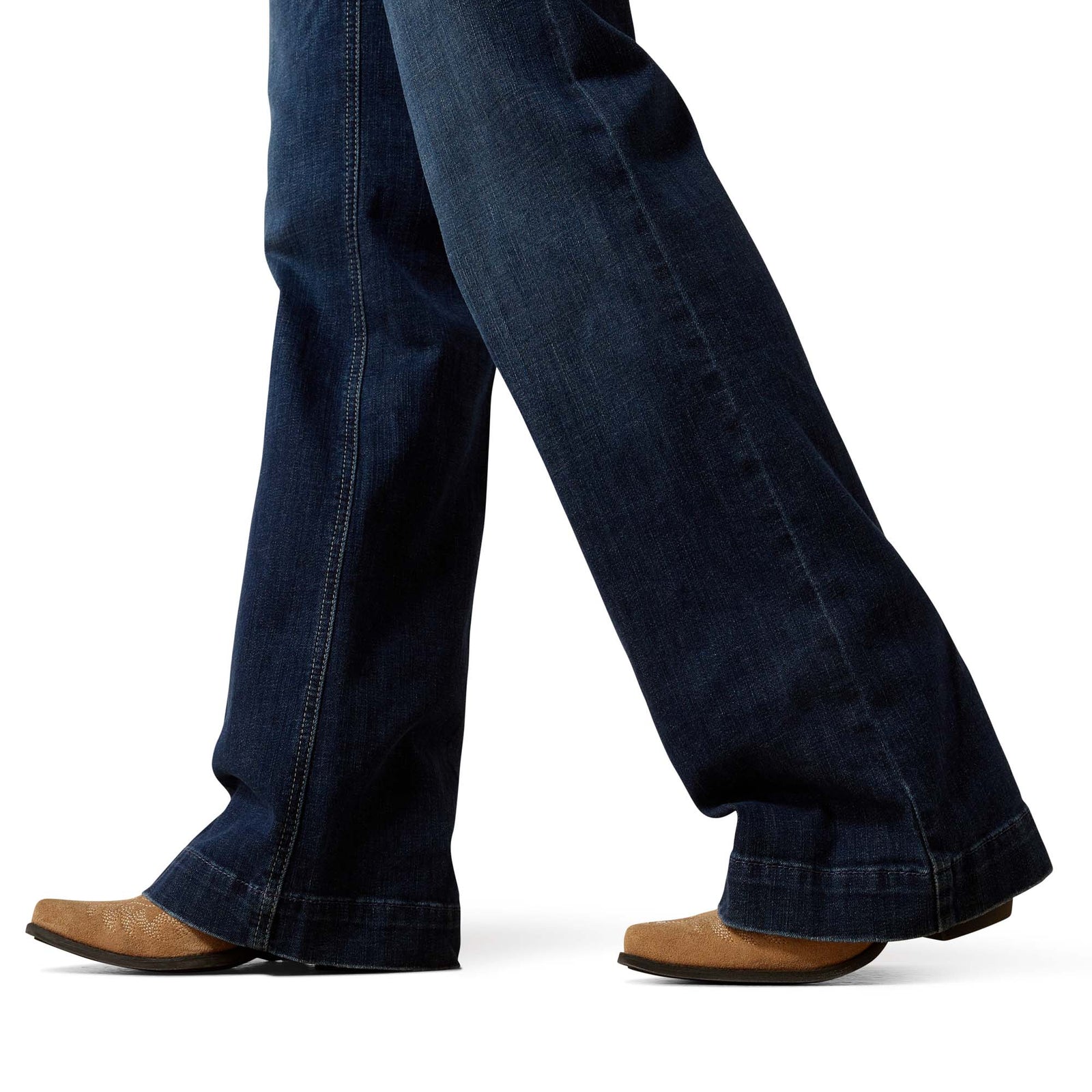 Dark blue jeans worn by a person on a white background