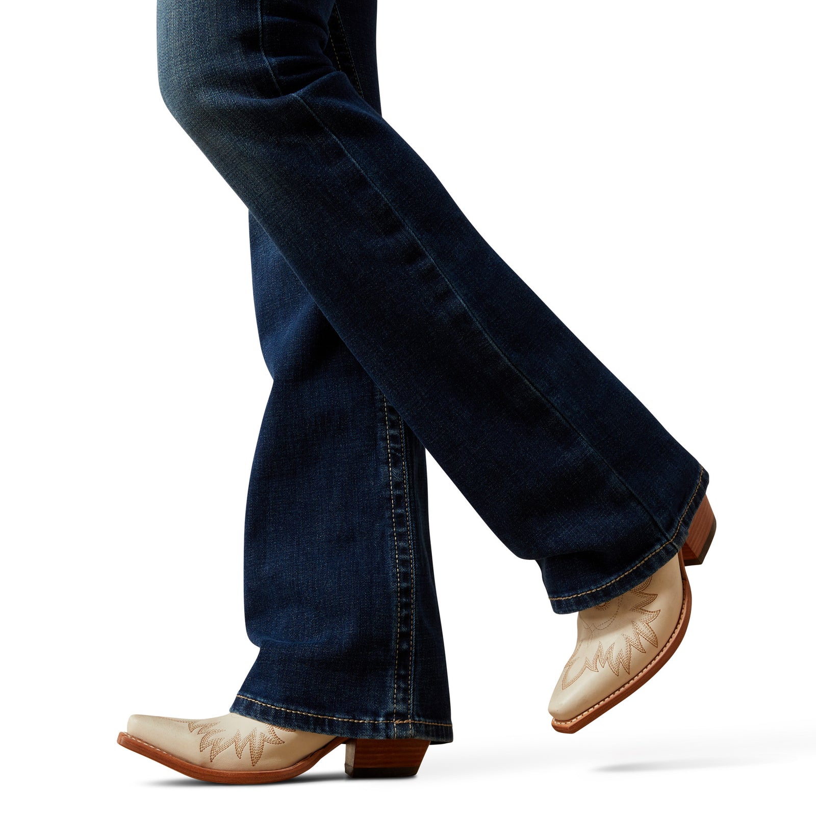 Close-up of blue jeans and white cowboy boots on a white background