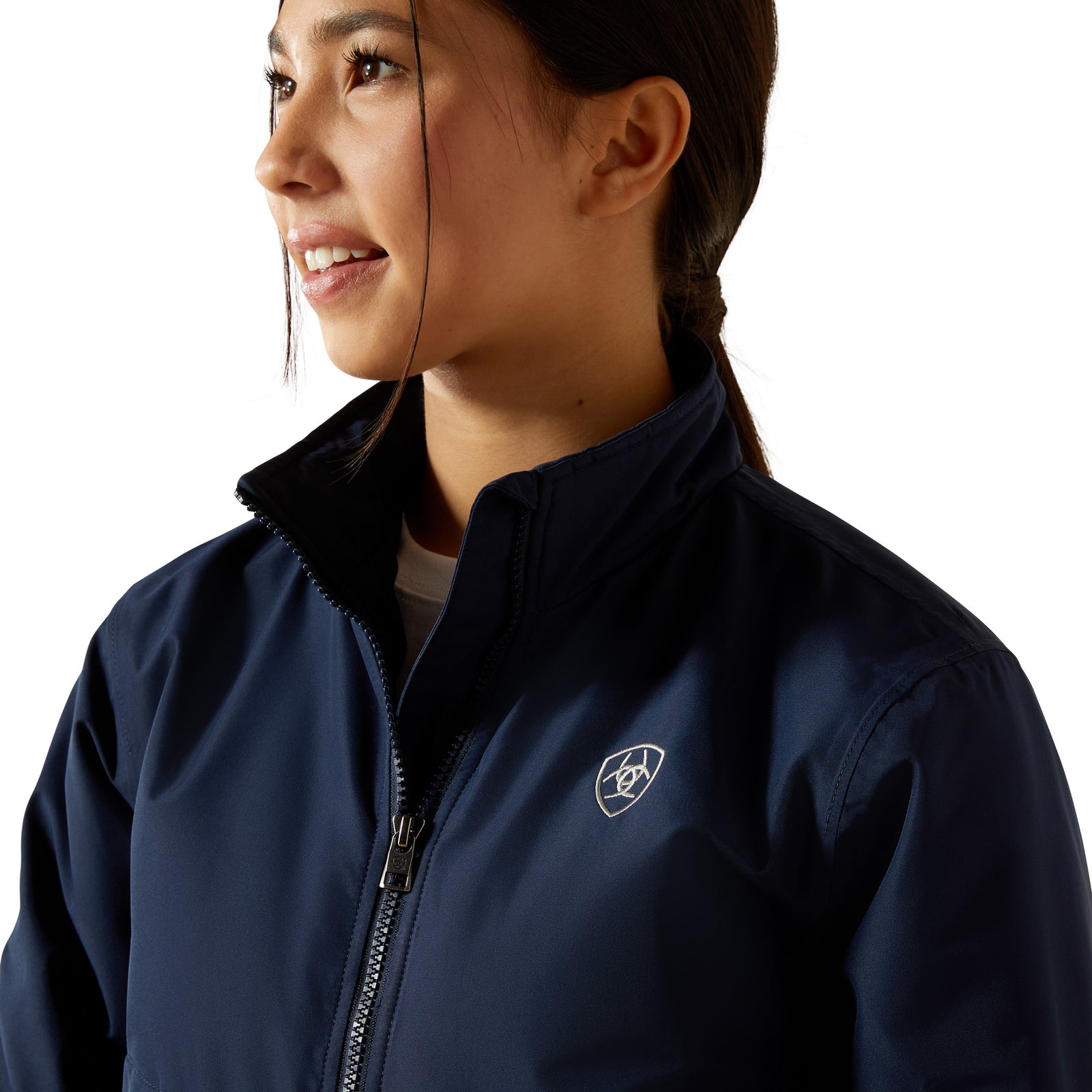 Woman wearing a navy blue jacket with a logo on a white background