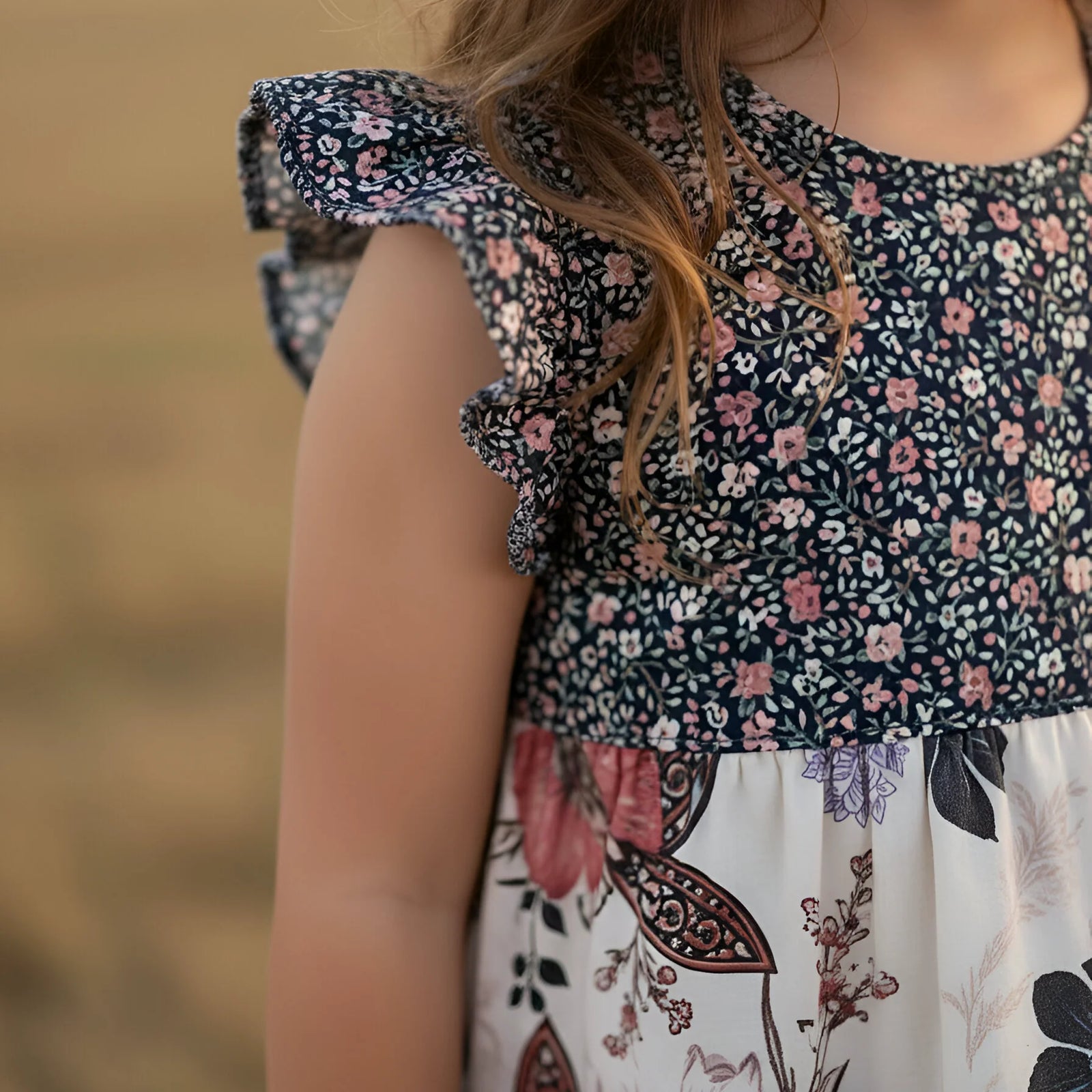 Close-up of a child wearing a floral dress with a blurred background