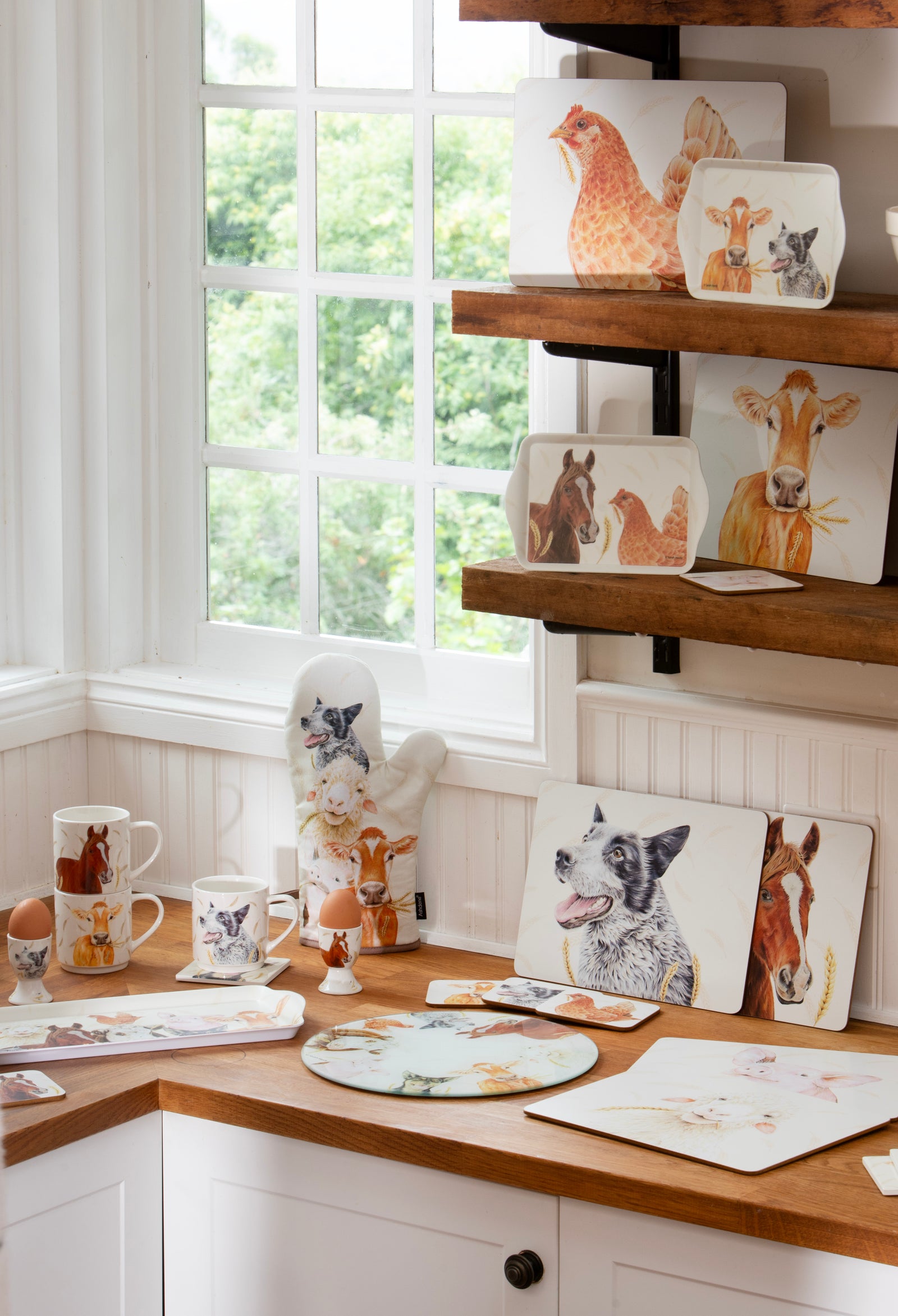 Decorative animal-themed plates and mugs on a wooden shelf and countertop.