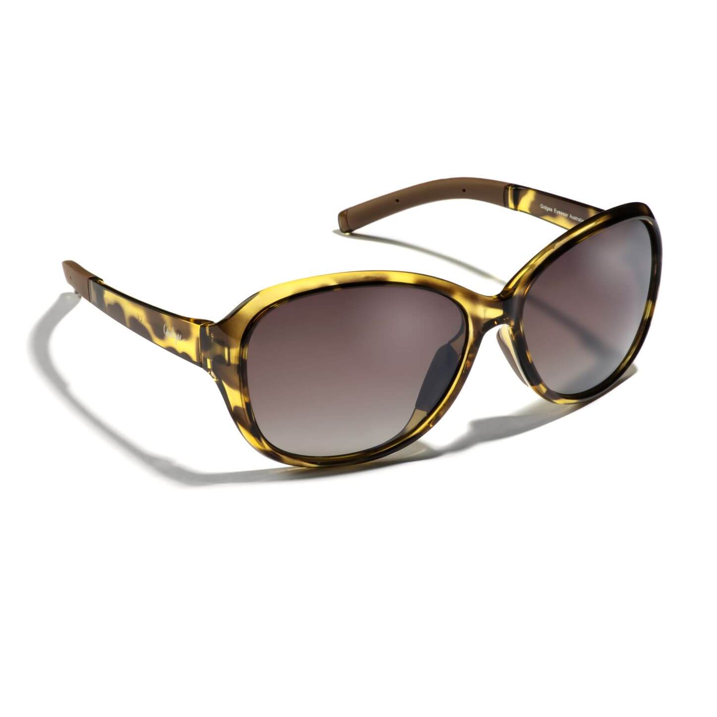 Gidgee Eyes Willow Yellowstone Sunglasses. A pair of sunglasses with a two-tone tortoise shell pattern on an emerald yellow base frame and natural bronze gradient injection polarized lenses.