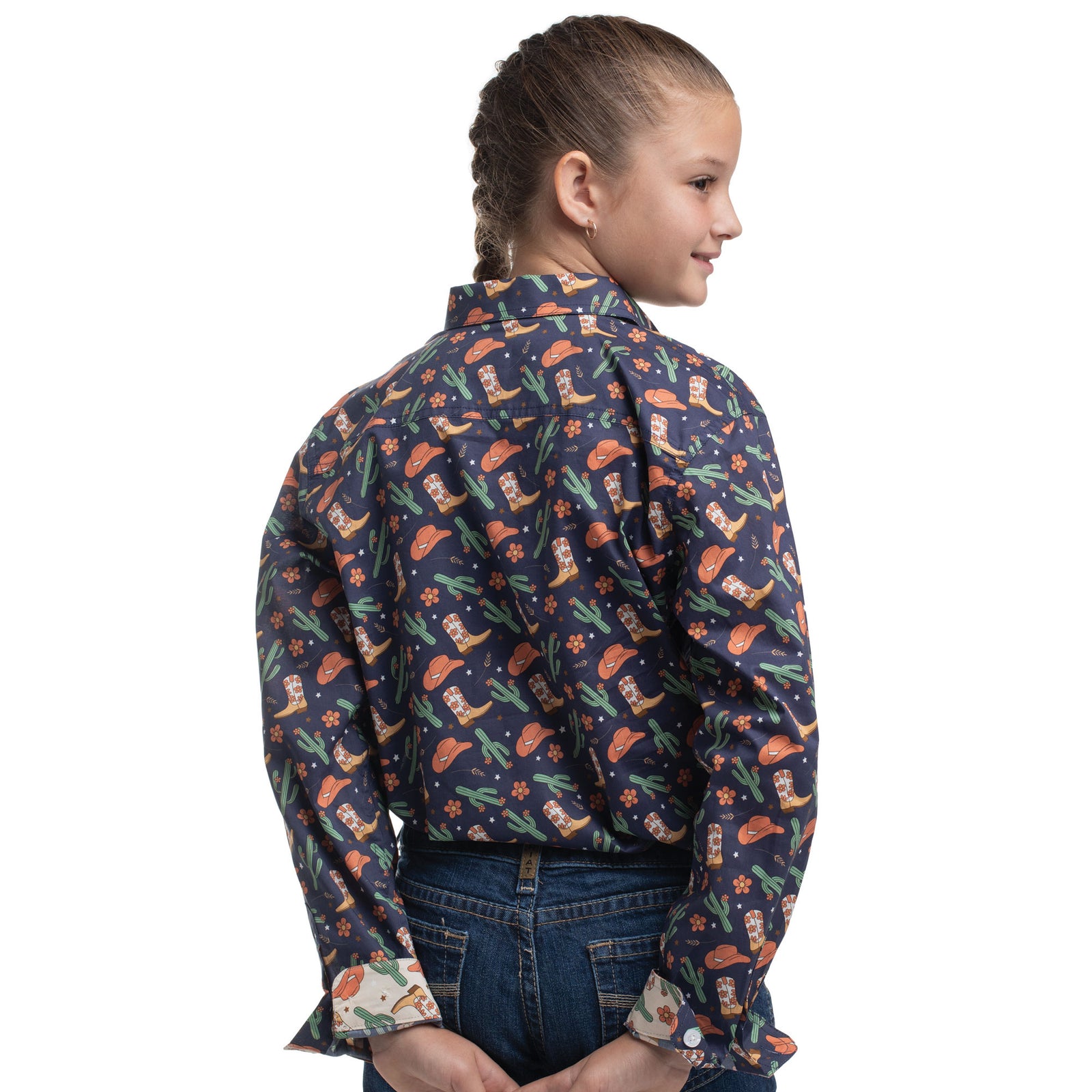 Girl wearing a patterned shirt with long sleeves on a white background