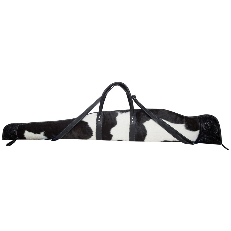 Black and white cowhide bag with a strap on a white background
