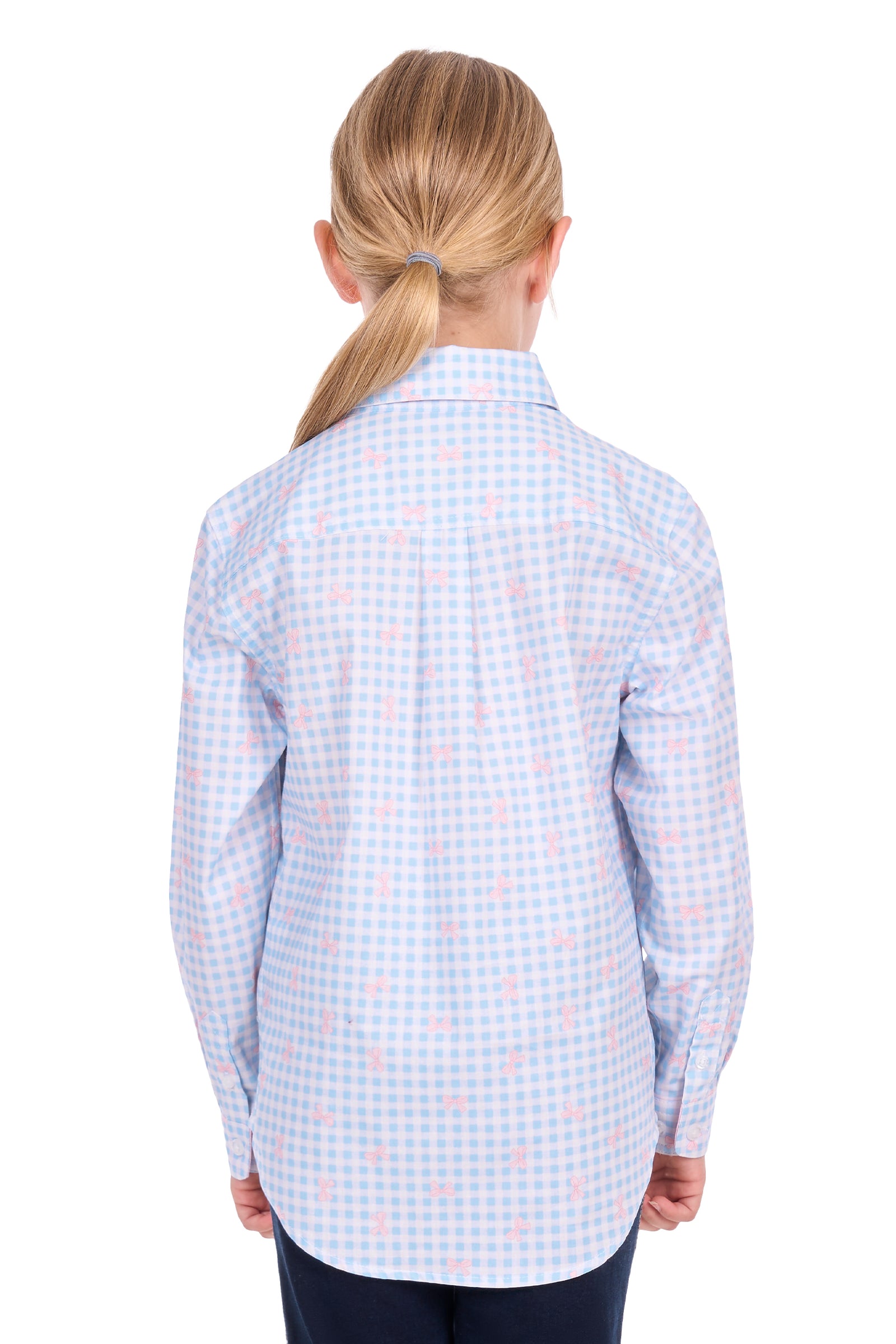 A child model shown from the back wearing a light blue and white gingham long-sleeve shirt with a small pink bow pattern, paired with dark navy pants, against a solid white background.