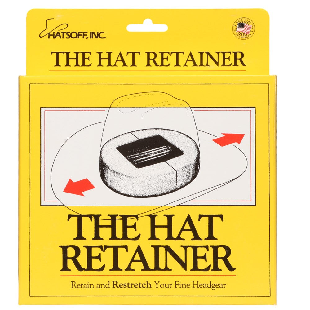 The Hat Retainer. Packaging of The Hat Retainer with yellow background and black text