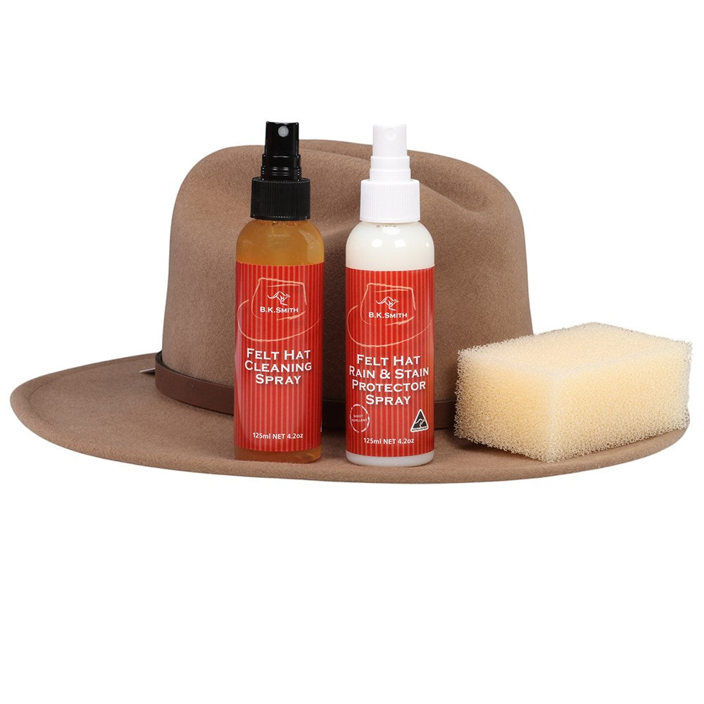 B.K. Smith Felt Hat Care Kit. Felt hat cleaning spray bottles with a sponge on a brown hat against a white background