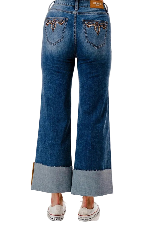 Blue jeans with a cuffed hem on a white background
