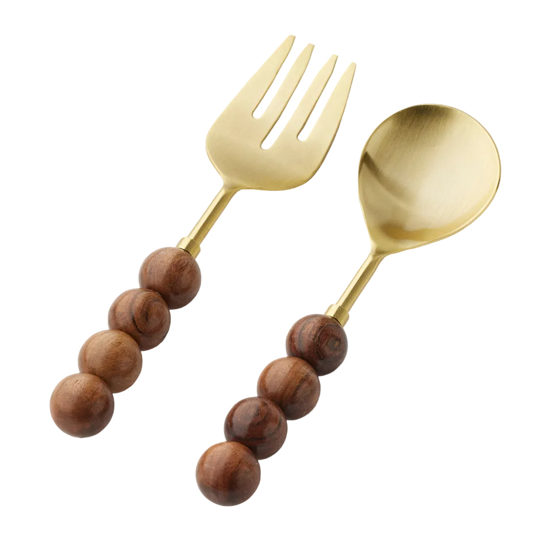 Gold fork and spoon with wooden bead handles on a light gray background
