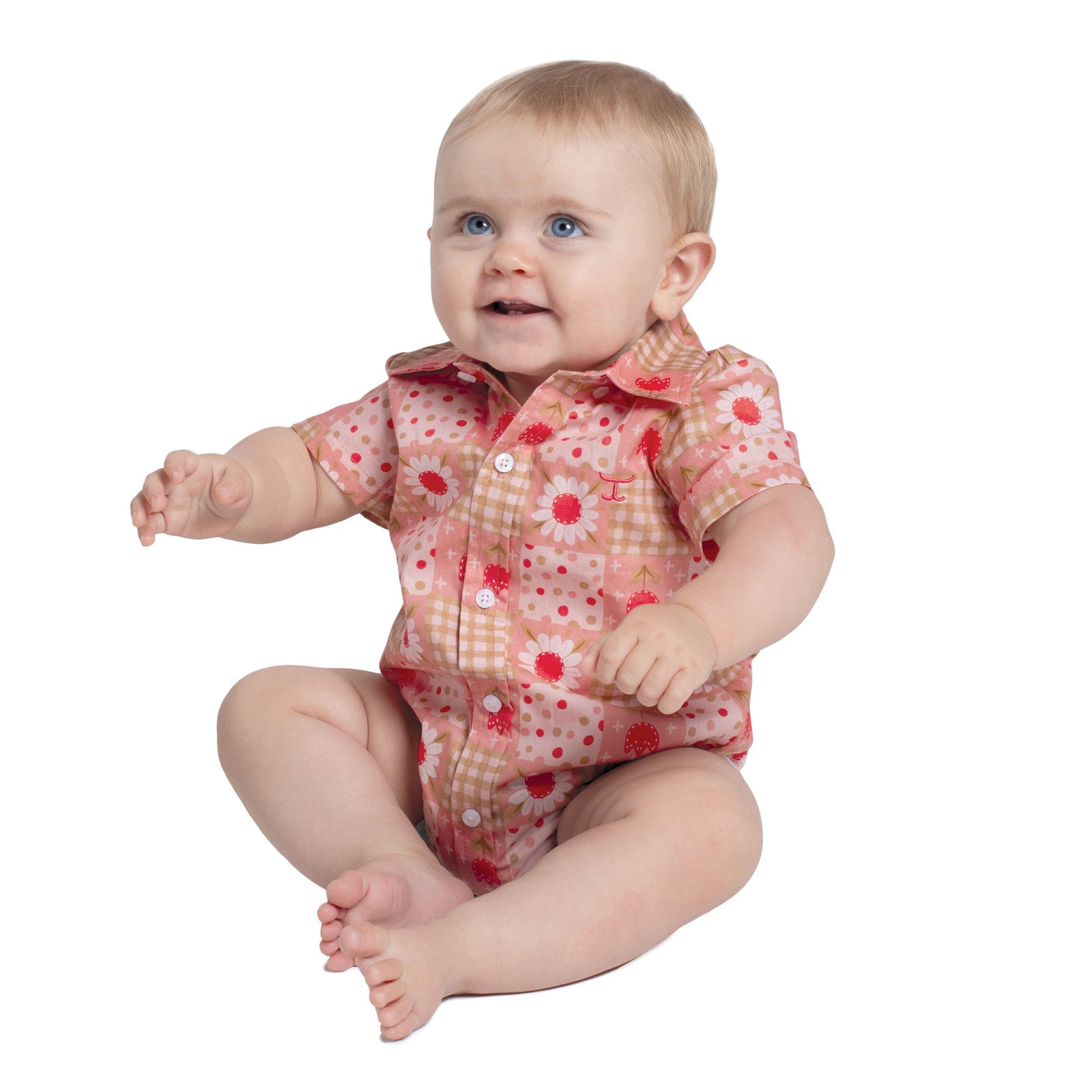 Baby wearing a floral onesie on a white background