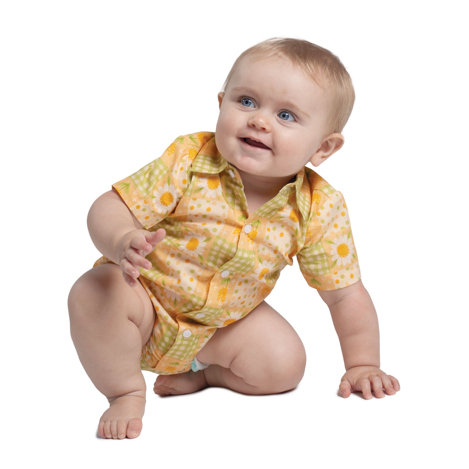 Baby wearing a yellow and green patterned onesie on a white background