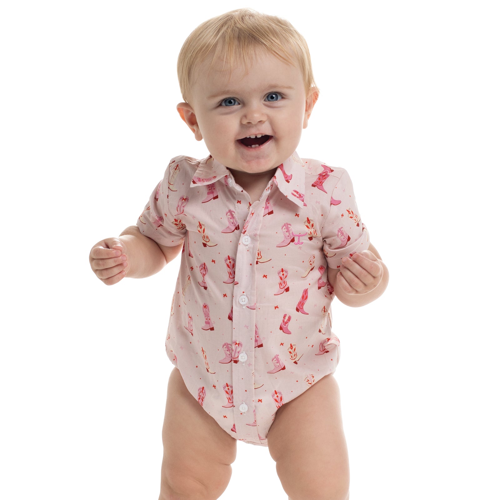 Baby wearing a pink shirt with floral patterns on a white background