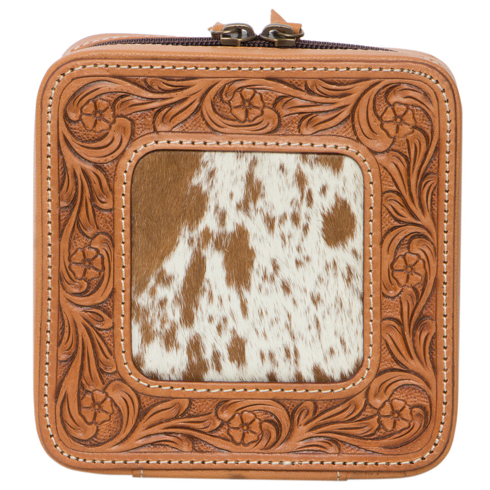 Tooling Cowhide Jewellery Box. Brown leather case with intricate patterns and a cowhide panel on a white background