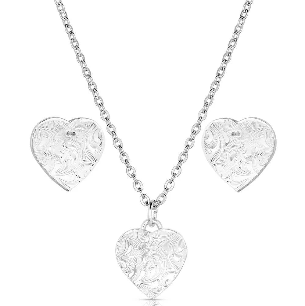 Montana Silversmiths Pure Heart Jewelry Set. Silver heart-shaped necklace and earrings on a white background