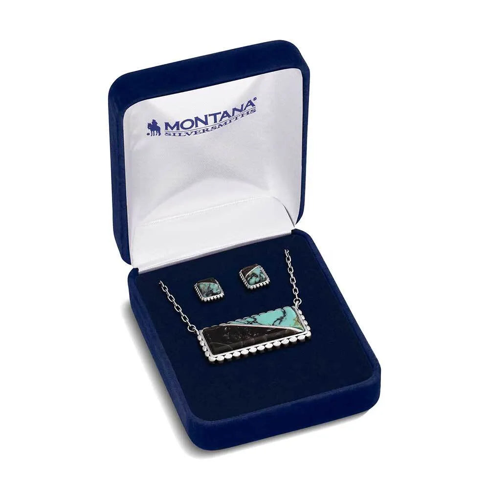 Two silver hoop earrings in a blue jewelry box with 'Montana Silversmiths' branding.