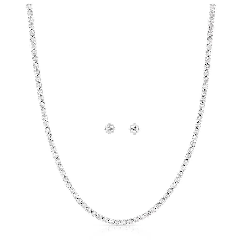 Silver necklace and earrings set on a white background