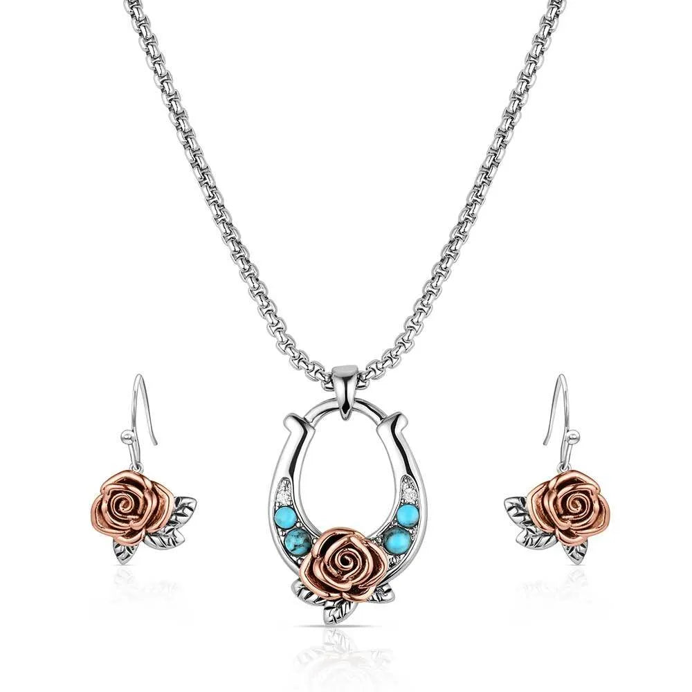 Jewelry set with rose and horseshoe design on a white background