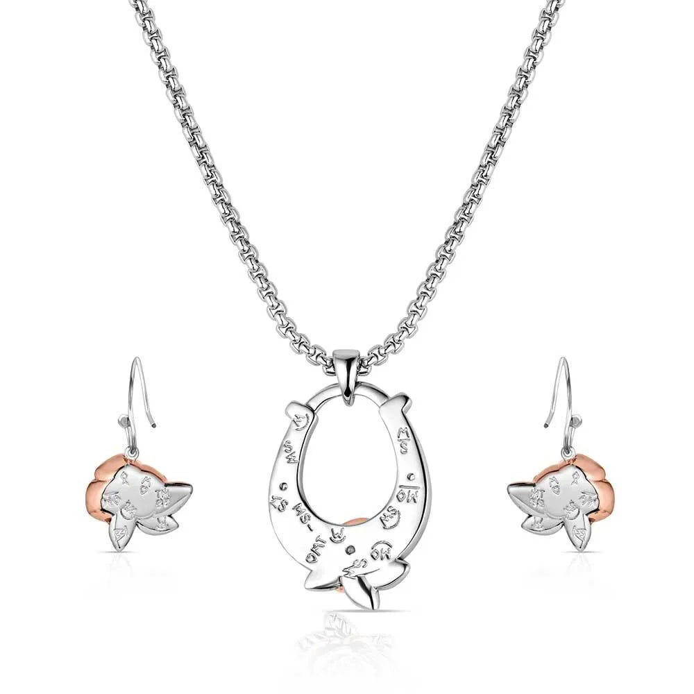 Jewelry set with a horseshoe pendant and star-shaped earrings on a white background
