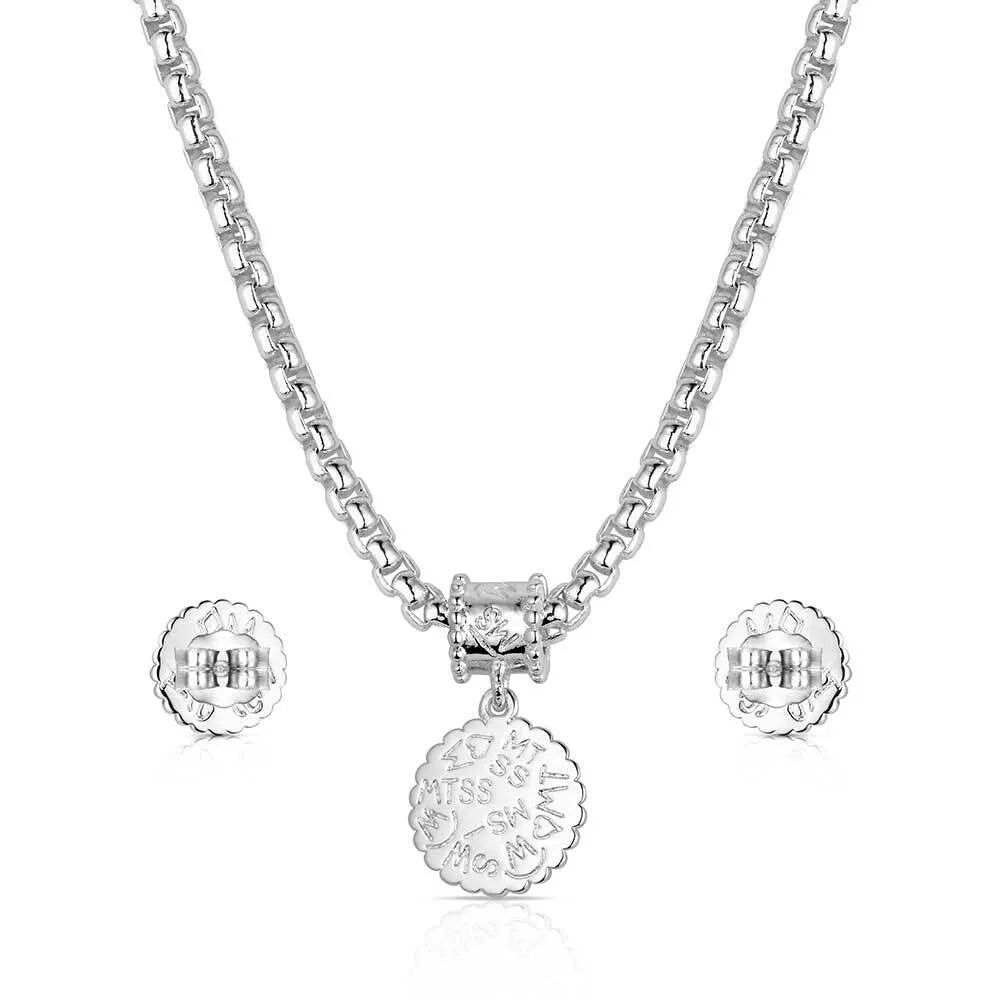 Silver necklace and earrings set on a white background
