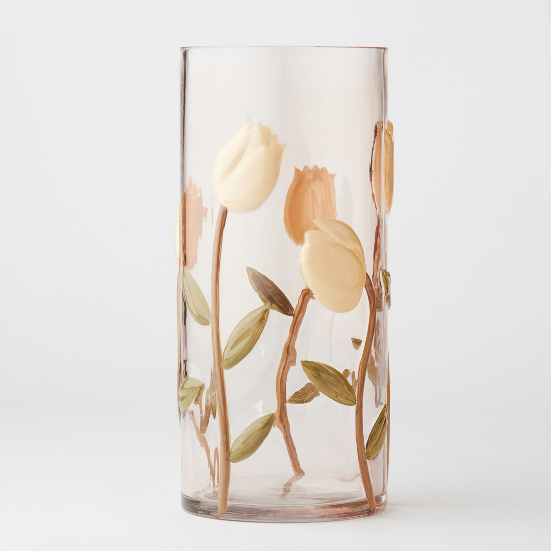 Tall glass vase with floral design on a white background