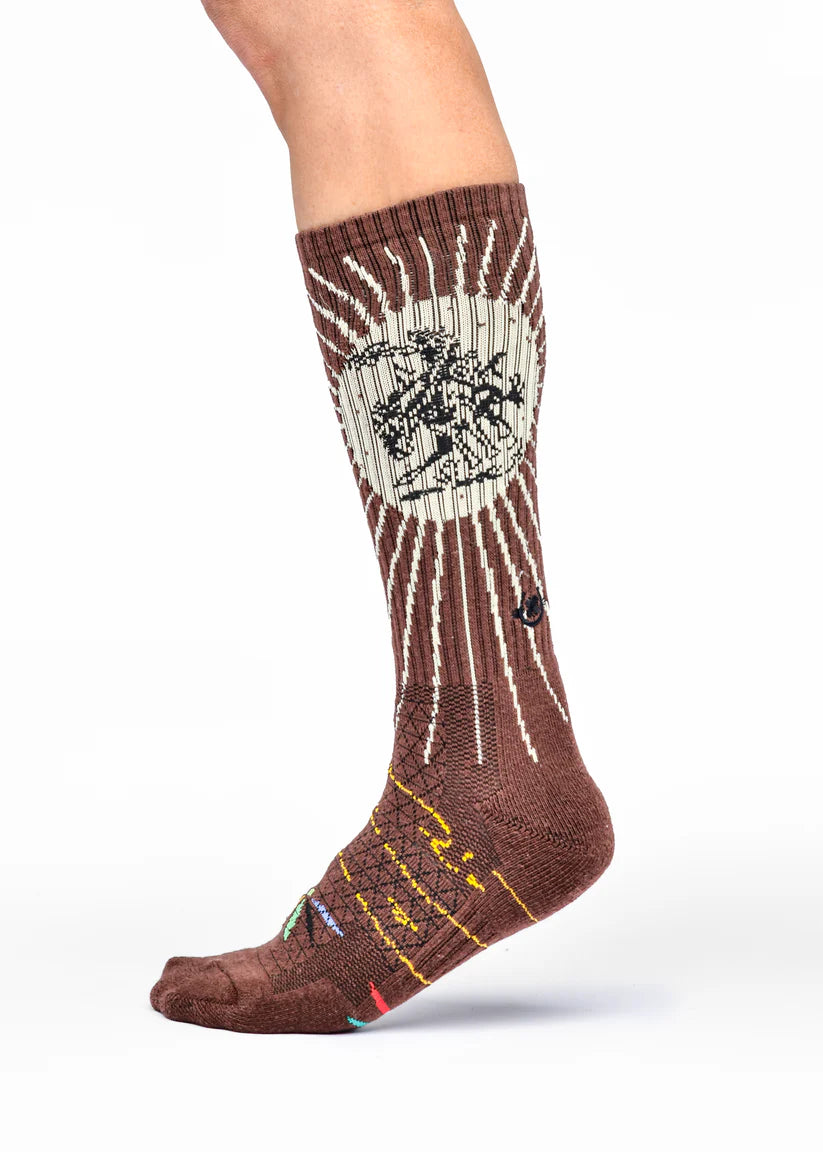 Lucky Chuck Fringe Bucking Western Cowgirl Performance Socks. Brown and white sock with a design on a white background