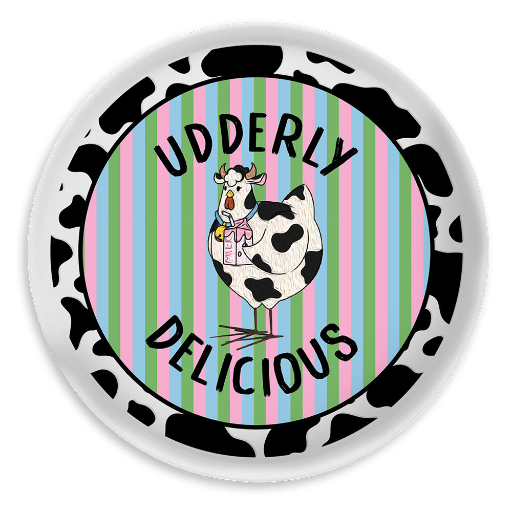 Circular sign with cow illustration and 'Udderly Delicious' text on a striped background