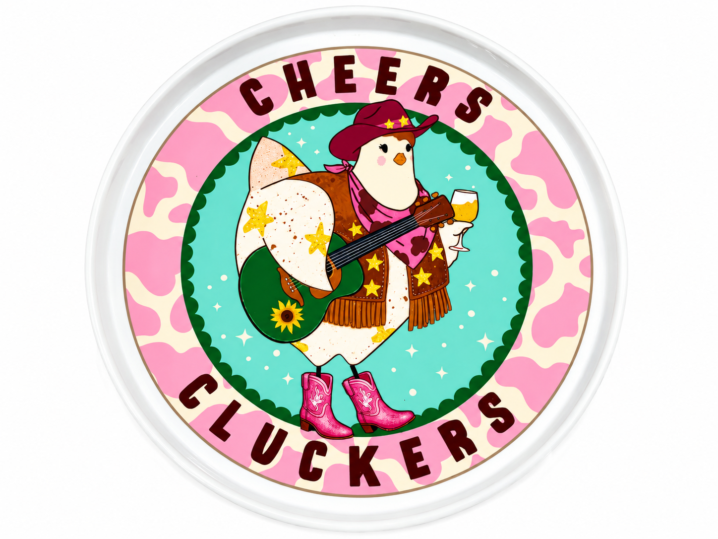 A round white decorative tray featuring a colorful printed design with the words 'CHEERS CLUCKERS' around a cartoon chicken dressed in western clothing and holding a guitar and mug.