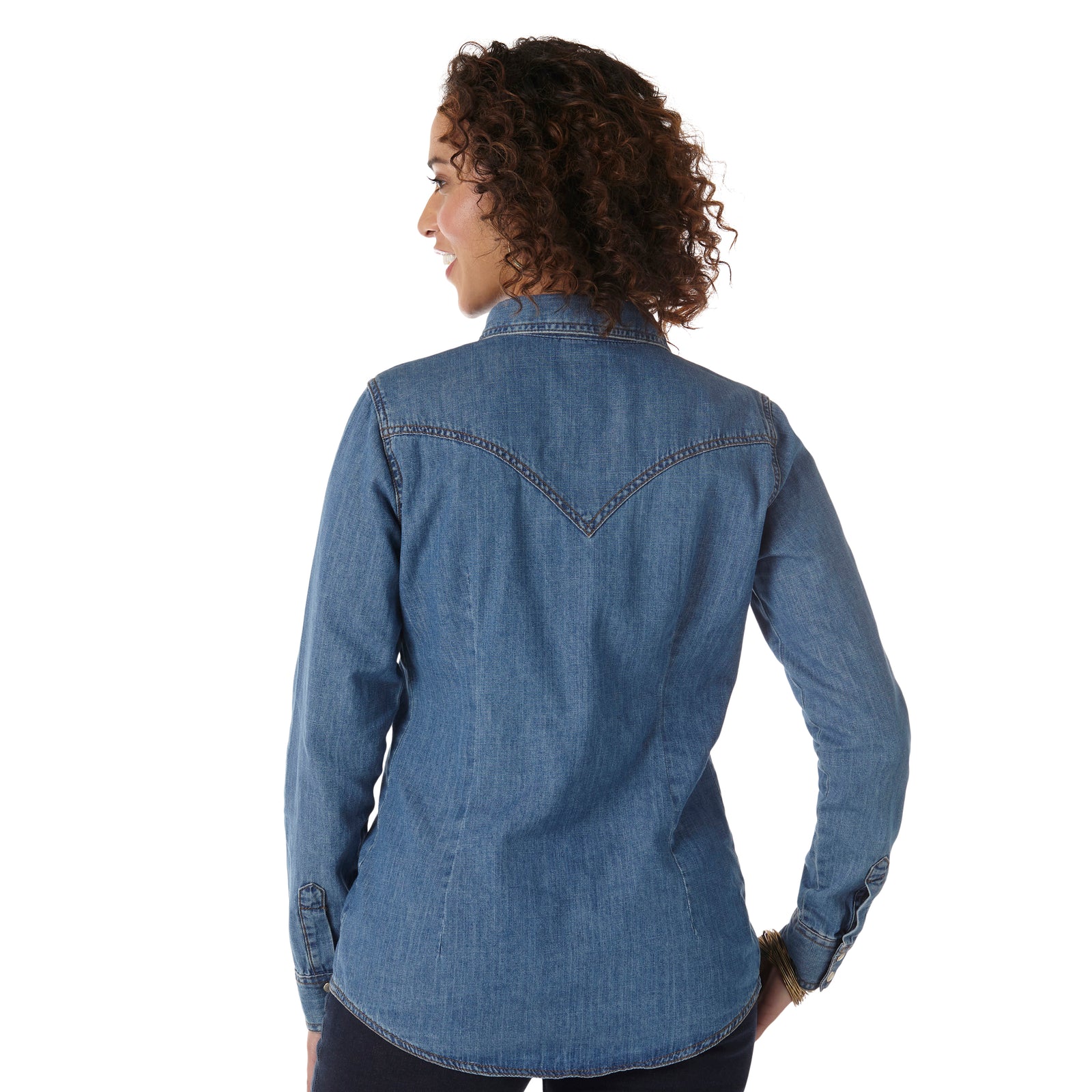 Wrangler Women's Classic Fit Denim L/S Western Shirt. Person wearing a blue denim shirt on a white background