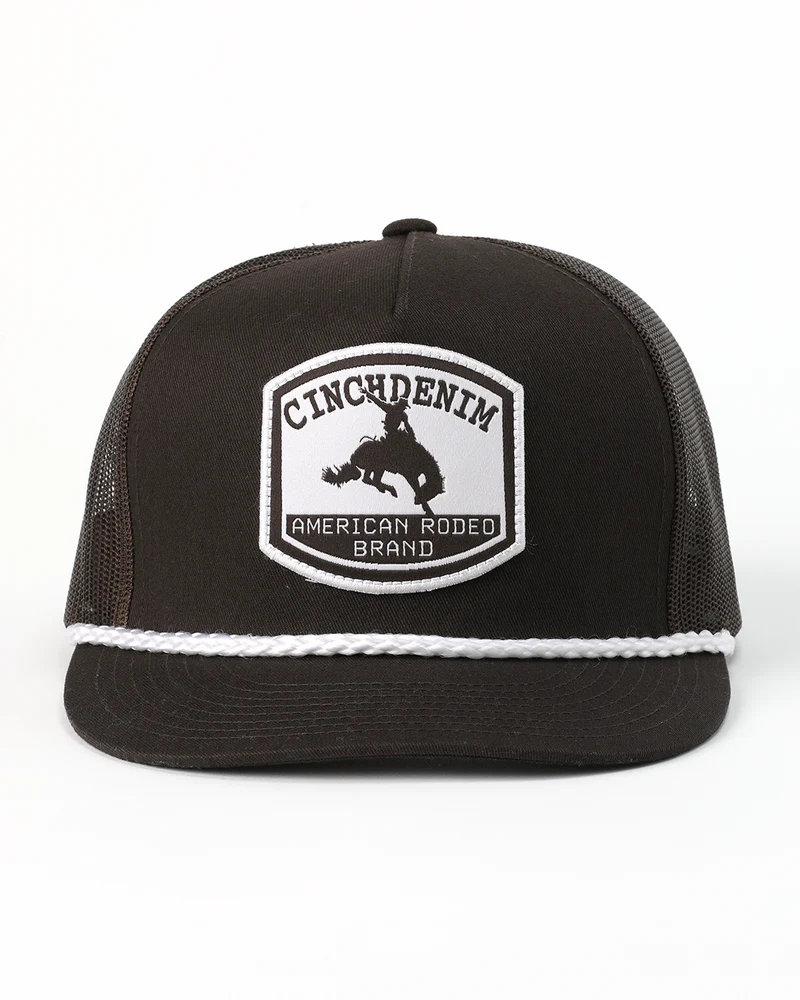 Cinch Men's High Profile Trucker Cap. Black trucker hat with white mesh and Cinch Denim logo on a white background