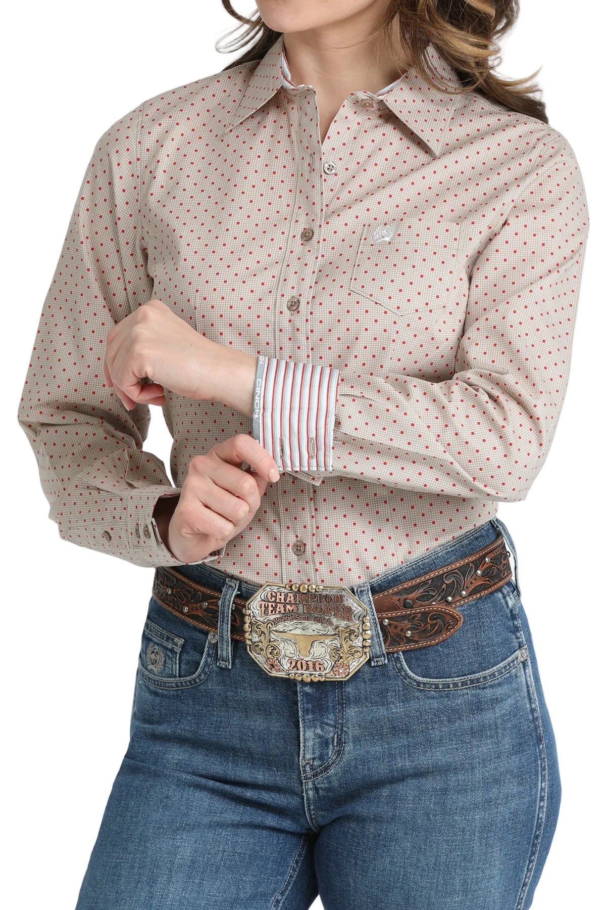 Person wearing a patterned shirt and jeans with a belt and buckle.