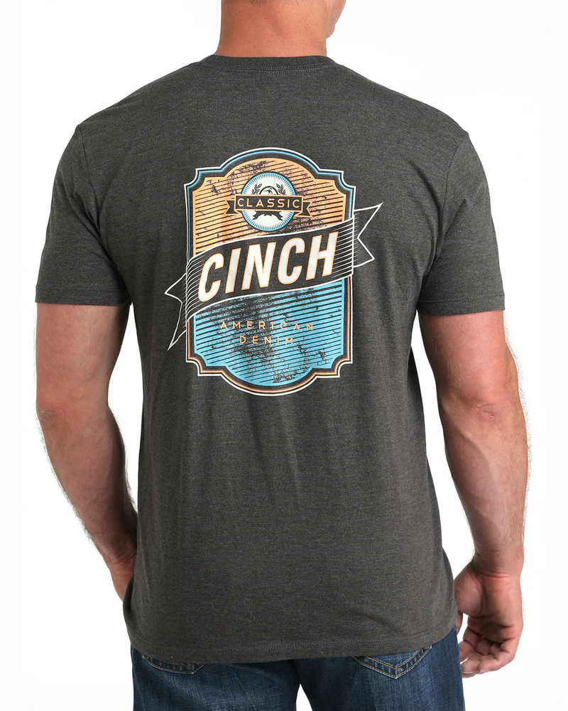 Cinch Men's Graphic T-Shirt. Person wearing a dark gray t-shirt with 'Cinch' logo on the back, on a white background