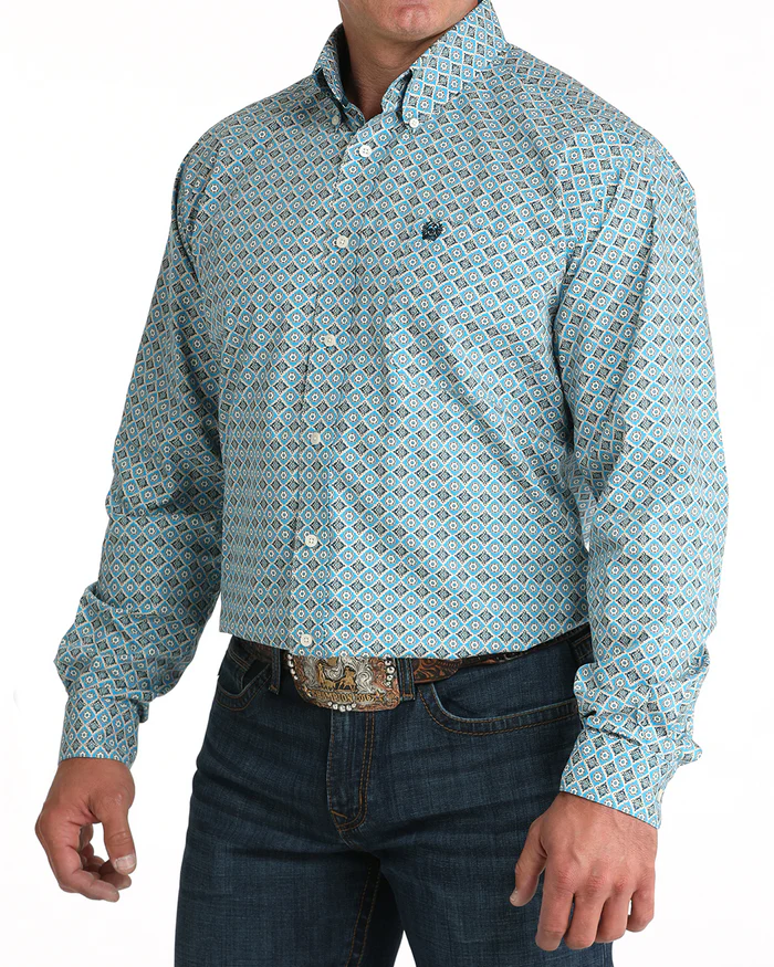 Cinch Men's Classic Fit Geometric Print L/S Western Shirt. Man wearing a patterned blue shirt and jeans on a white background
