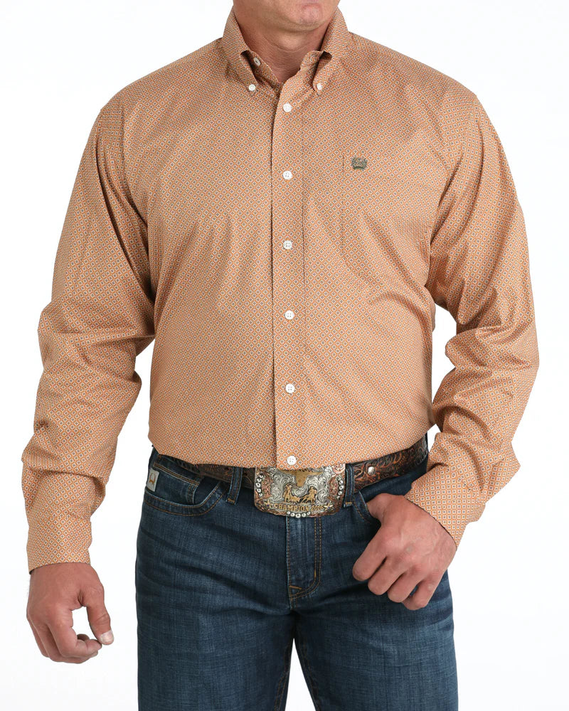 Cinch Men's Stretch Classic Fit Button-Down Western Shirt. Man wearing a beige patterned shirt and blue jeans on a white background