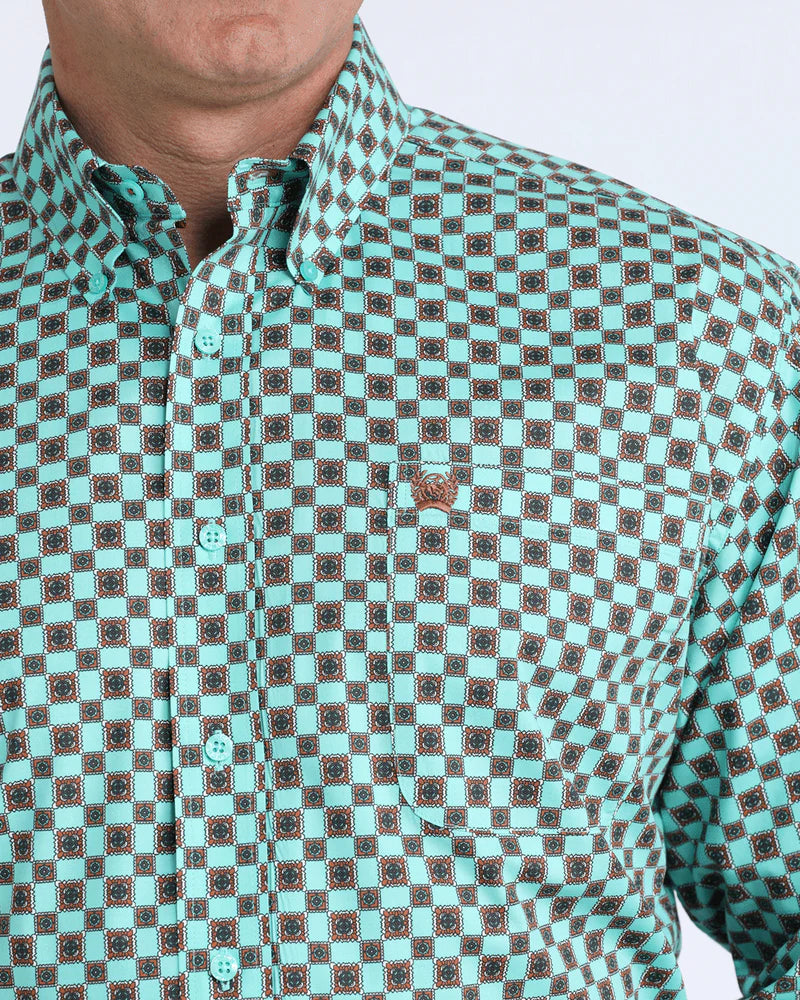 Teal patterned shirt worn by a person on a white background
