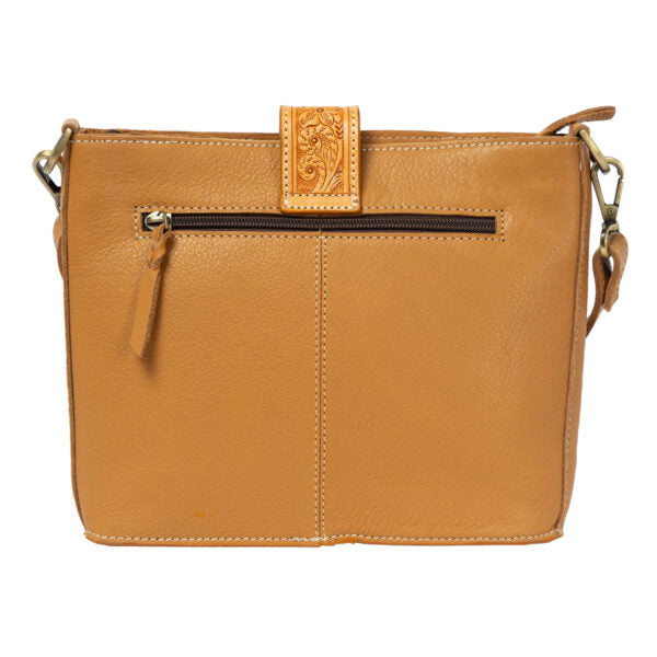 A tan leather crossbody bag with a front zippered pocket, an embossed floral detail on a vertical leather tab, and a matching leather tassel pull, shown against a plain white background.