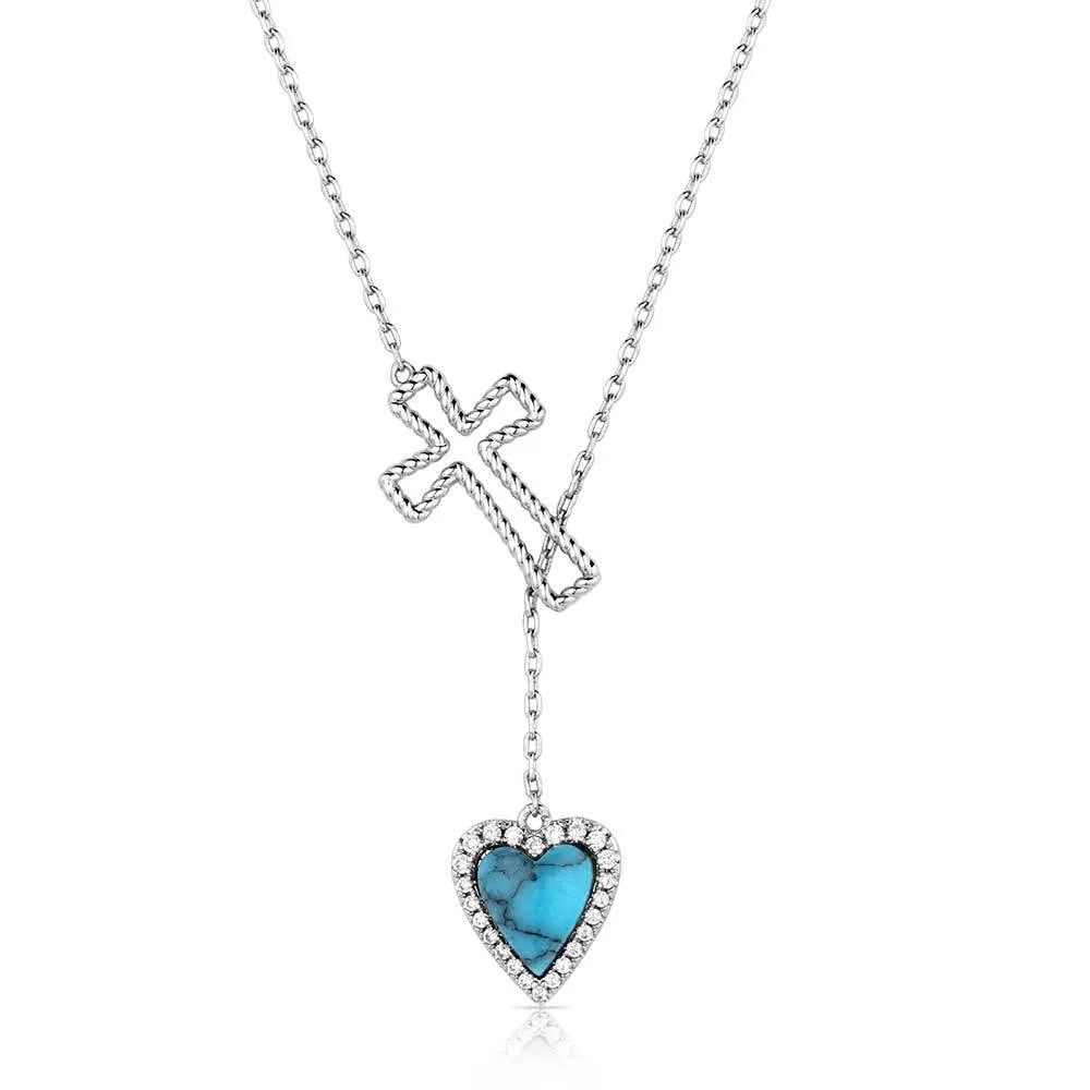 Necklace with a turquoise heart pendant and cross on a white background