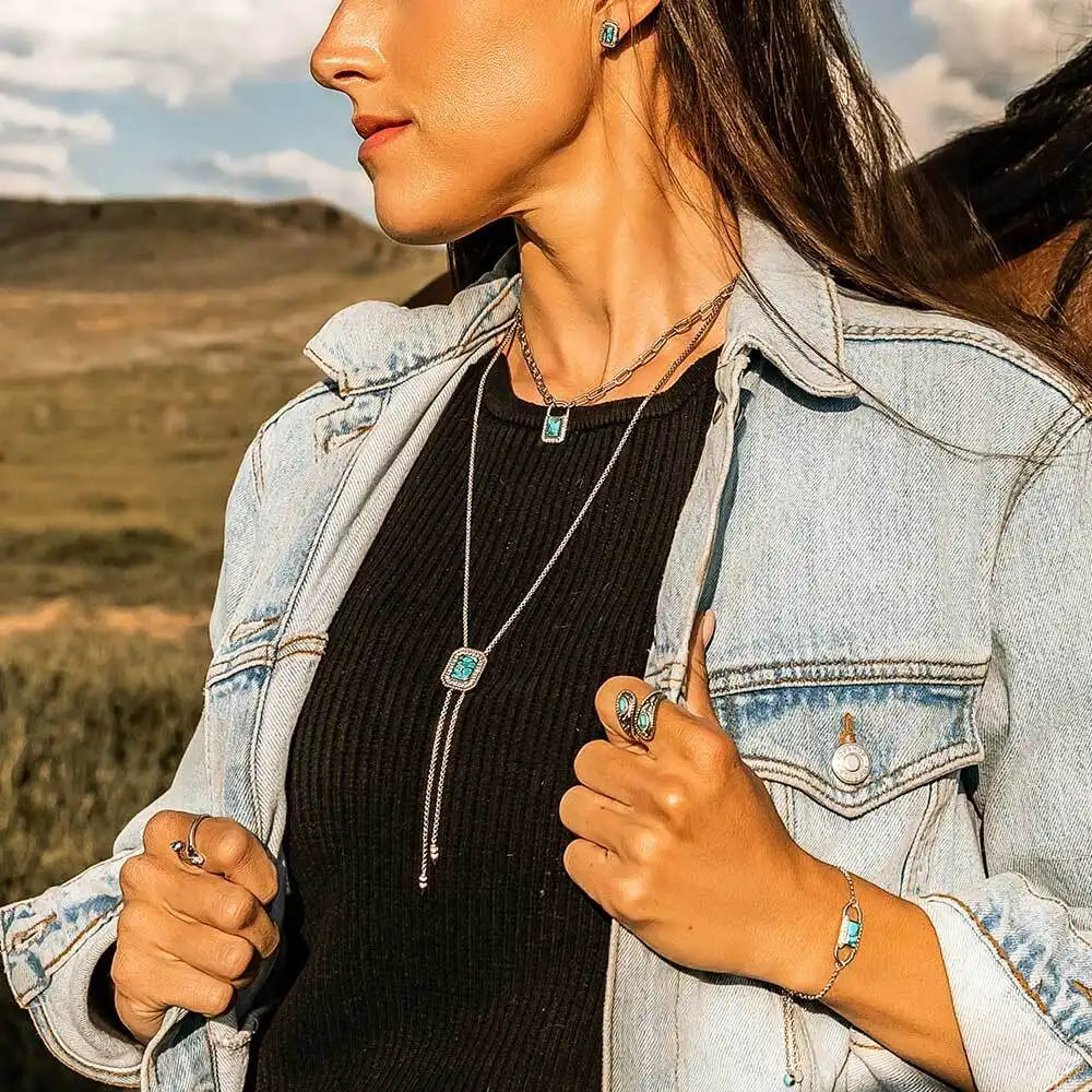 Woman wearing a necklace with a scenic background