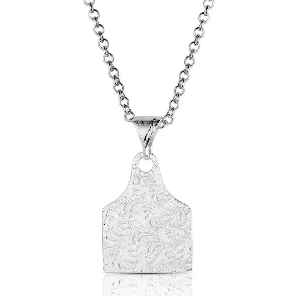 Silver pendant necklace with intricate design on a white background