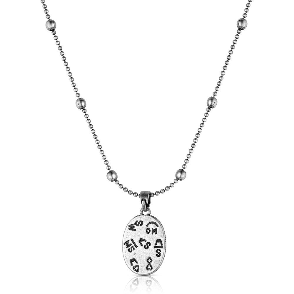 A silver-toned necklace featuring a beaded chain with a polished oval pendant engraved with various symbols, shown against a plain white background.
