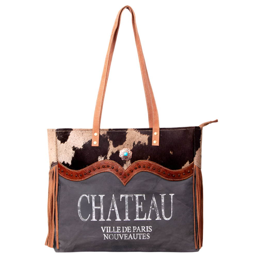 American Darling canvas and leather weekend bag with a 'CHATEAU' print on the front, brown straps, and a floral embossed leather detail.