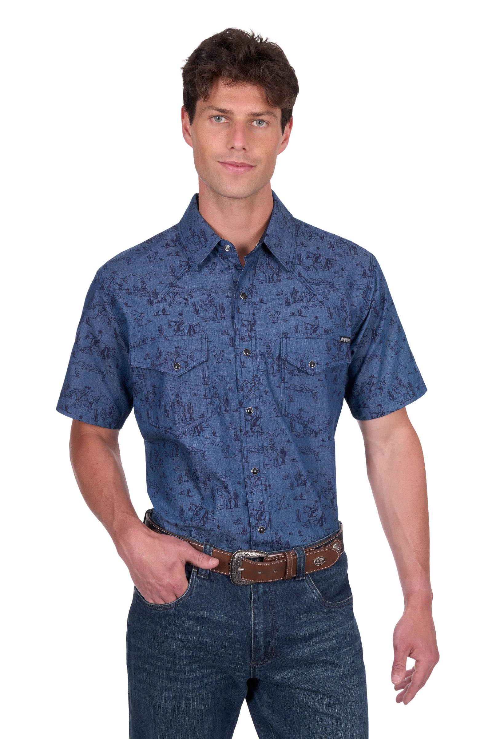 Pure Western Men's Travis S/S Western Shirt. Man wearing a blue patterned shirt and jeans on a white background
