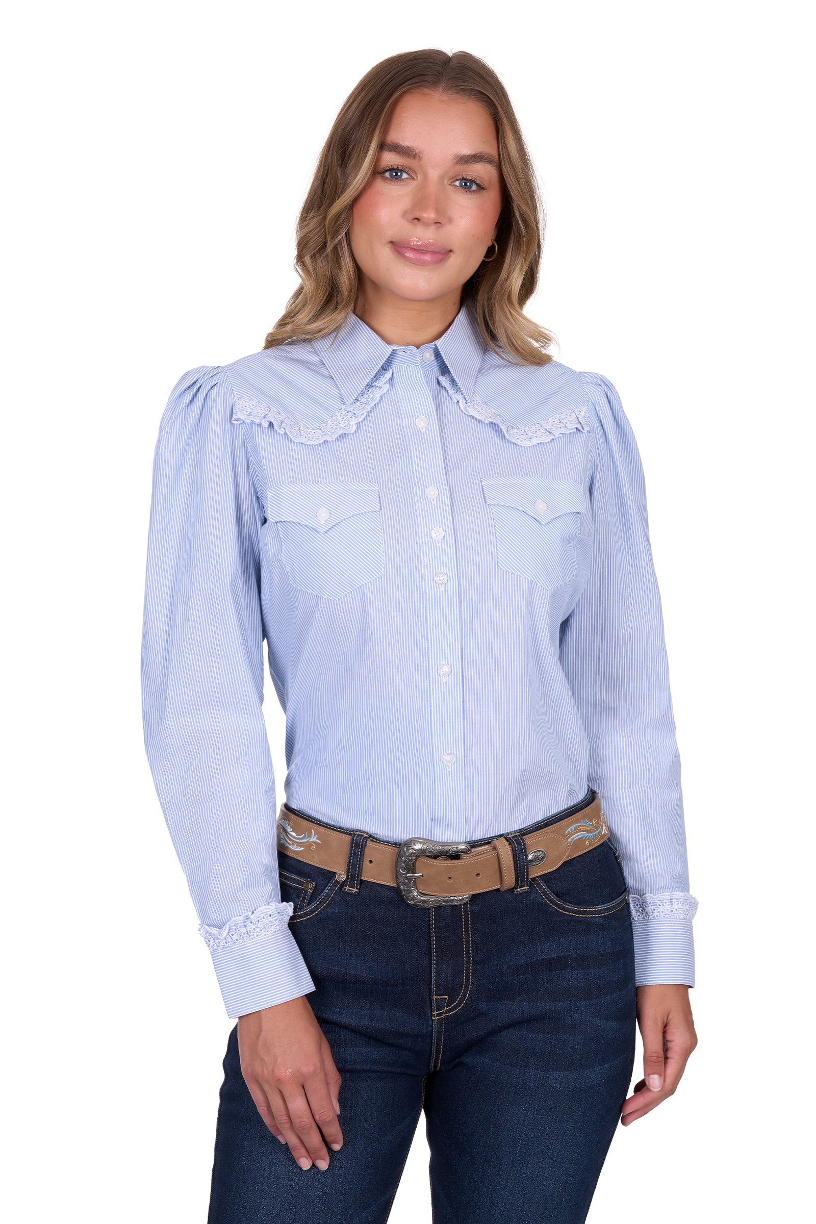 Pure Western Women's Lexi L/S Western Shirt. Woman wearing a light blue denim shirt and dark jeans on a white background