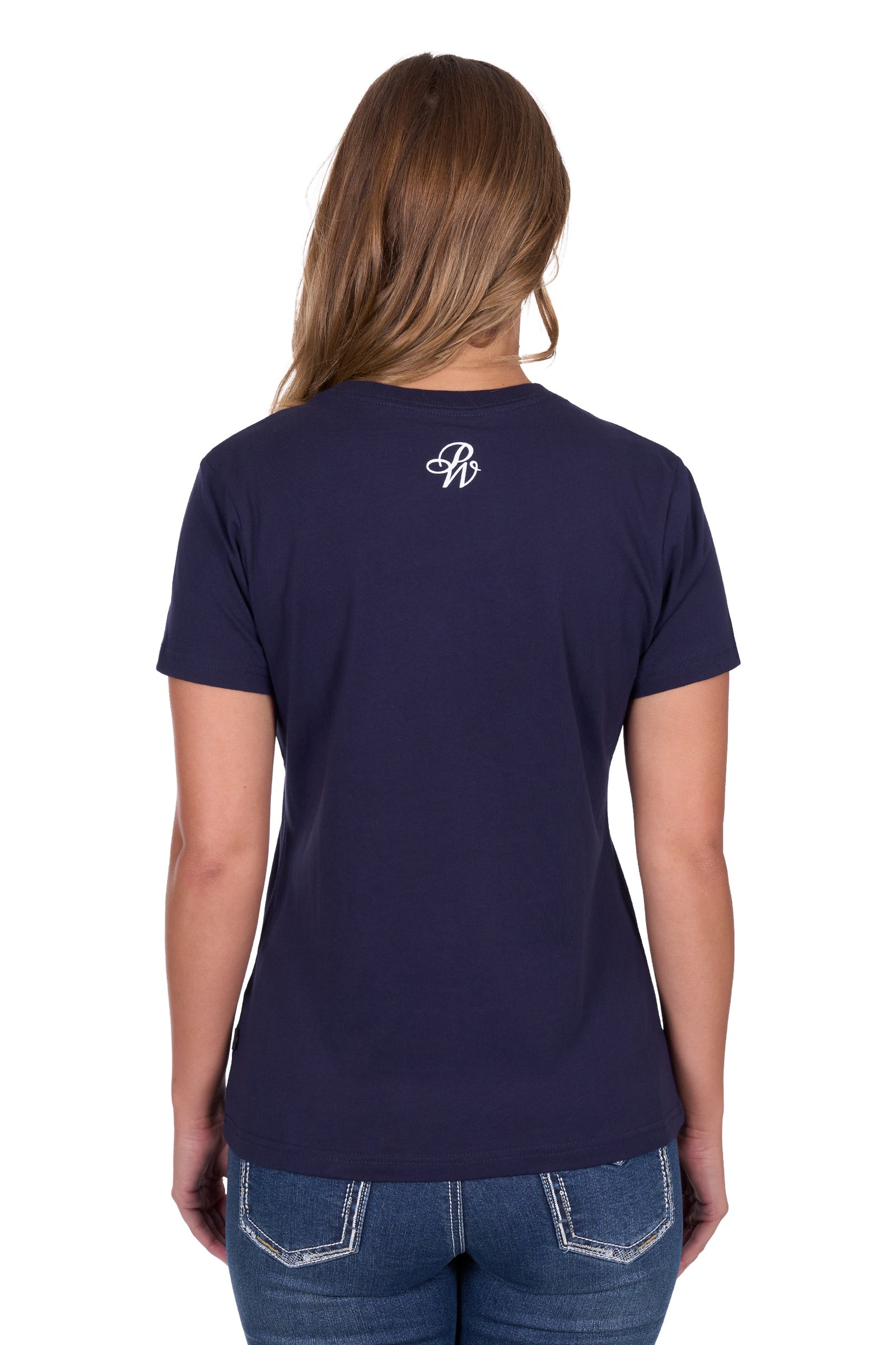 Pure Western Women's Sherry T-Shirt. Person wearing a navy blue t-shirt with a logo on the back, standing against a white background