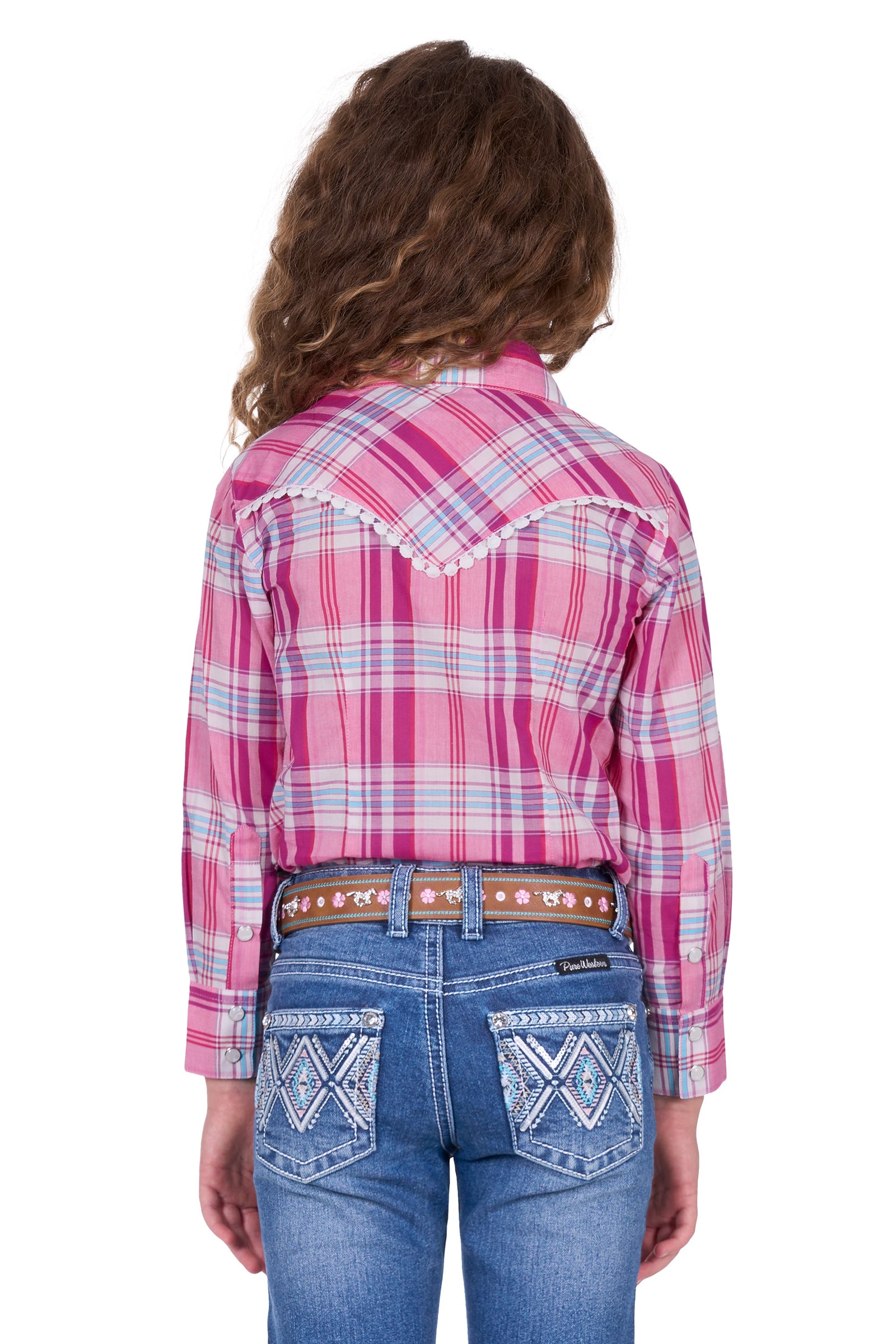 Pure Western Girl's Leni L/S Western Shirt. Person wearing a pink plaid shirt and blue jeans on a white background
