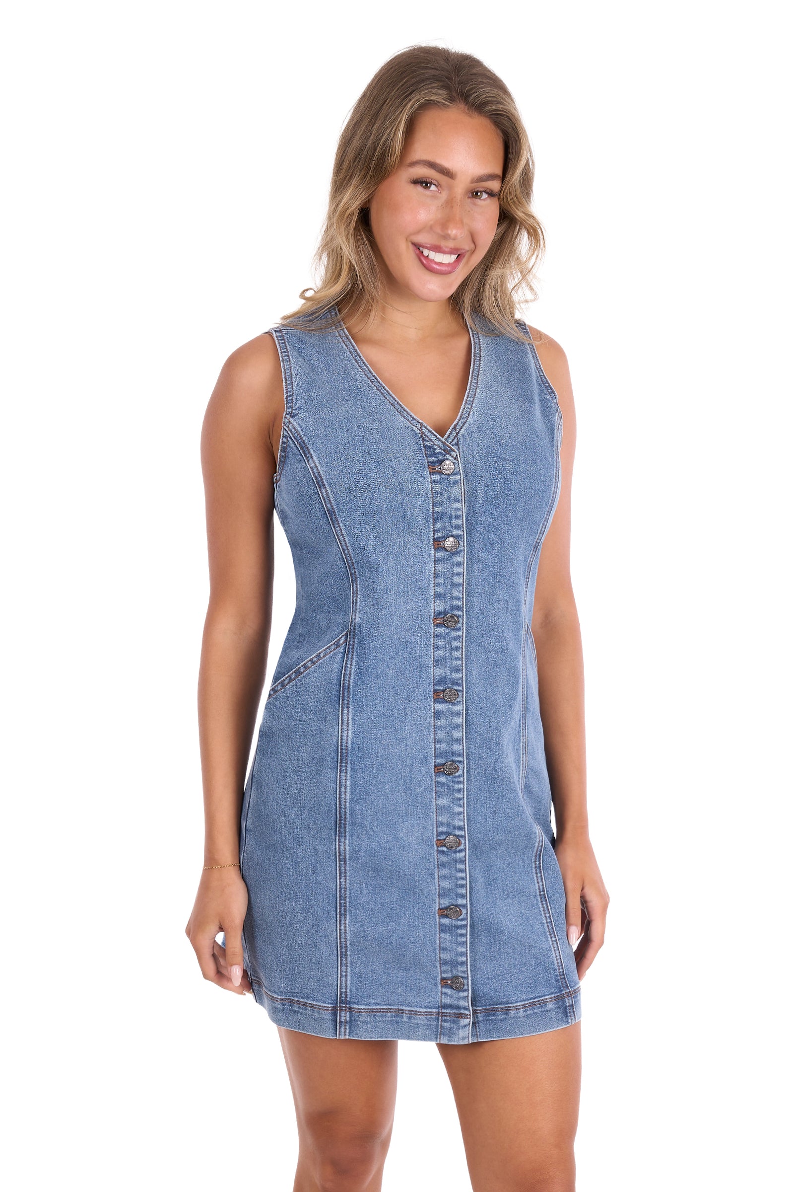 A woman modeling a sleeveless light blue denim dress with a button-down front, photographed against a plain white background.
