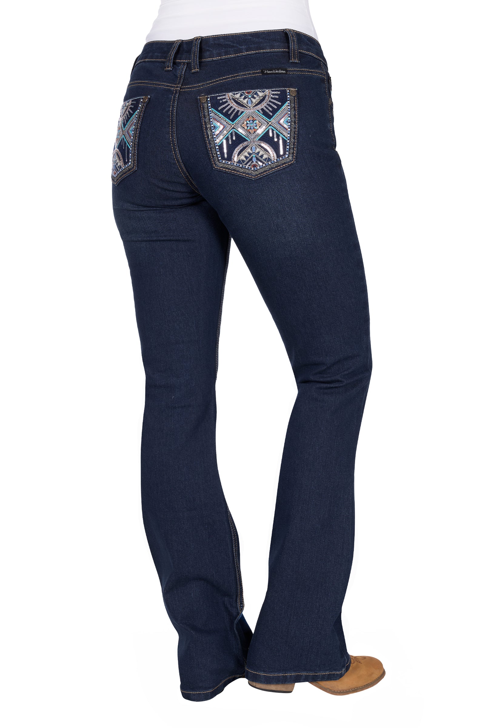 Pure Western Women's Ana Boot Cut Jean. Dark blue jeans with decorative back pockets on a white background