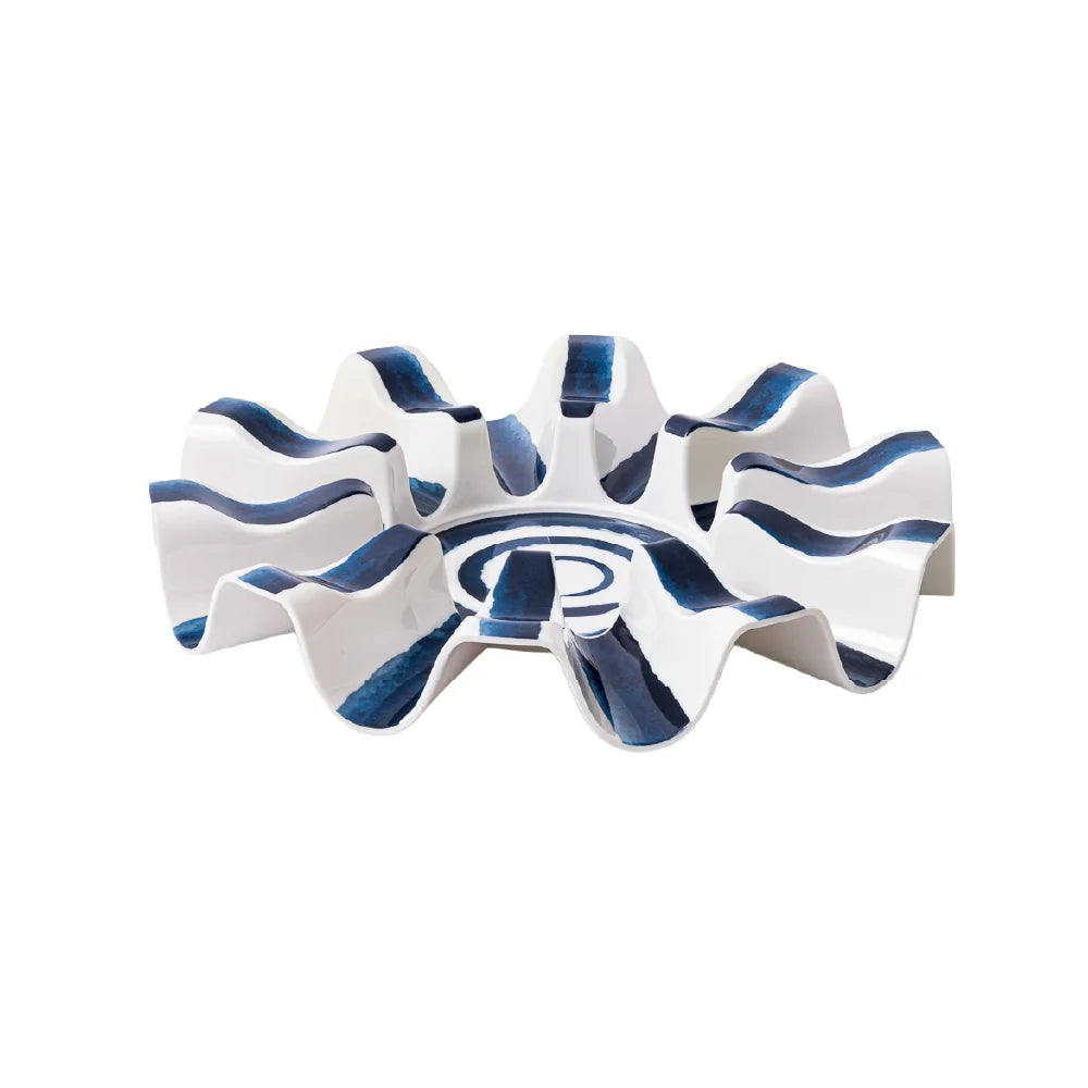 A modern, sculptural ceramic ashtray with a wavy, gear-like design in white and dark blue, shown on a plain white background.