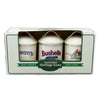 A boxed set of three vintage-style ceramic canisters displayed in a white retail box. The canisters are off-white with metal lids and handle cutouts, featuring printed labels for 'Anott's', 'Single Best Bushells', and 'Rosella Rose'.