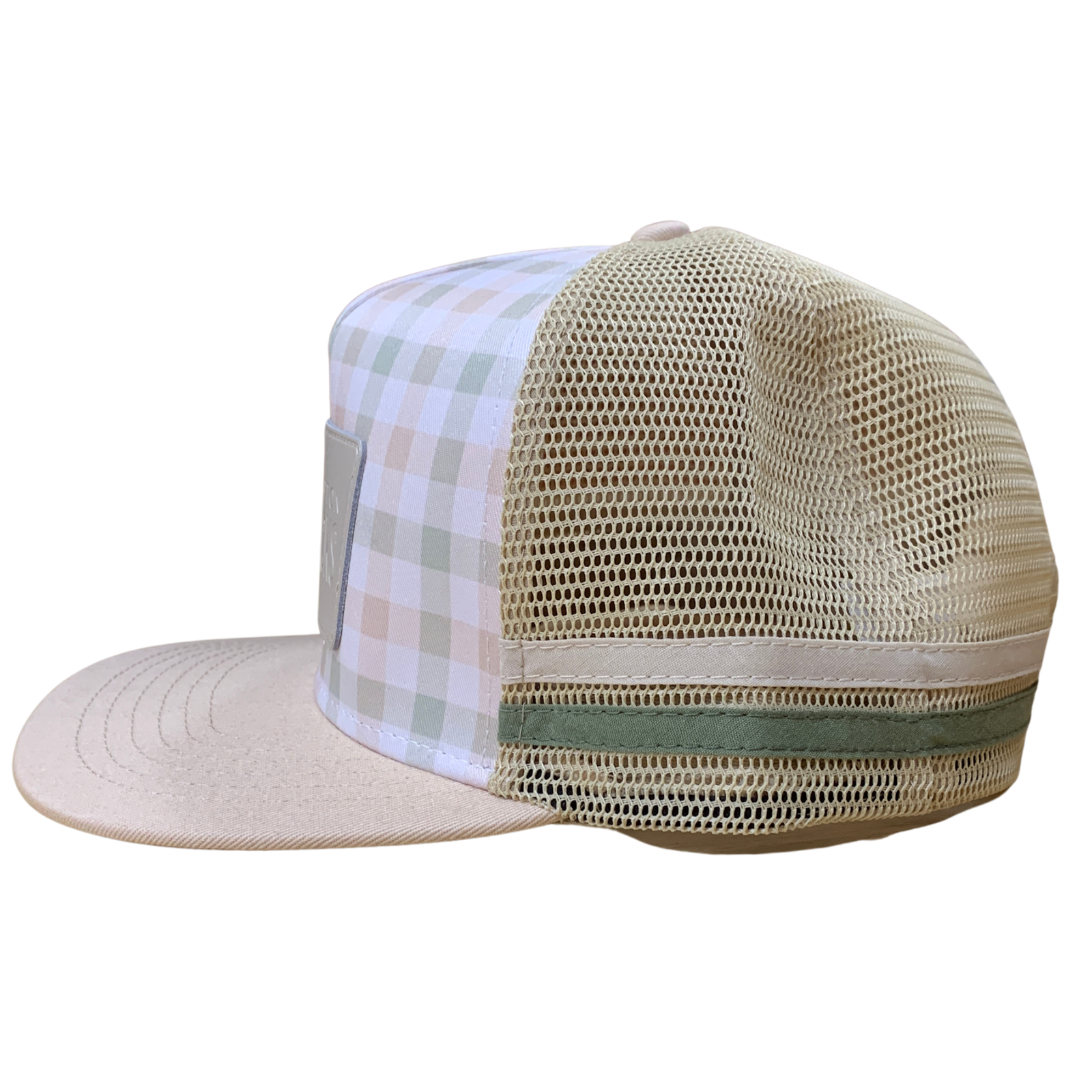 A beige trucker-style cap with a beige mesh back, a flat brim, and a front panel featuring a white, beige, and pale green plaid pattern.