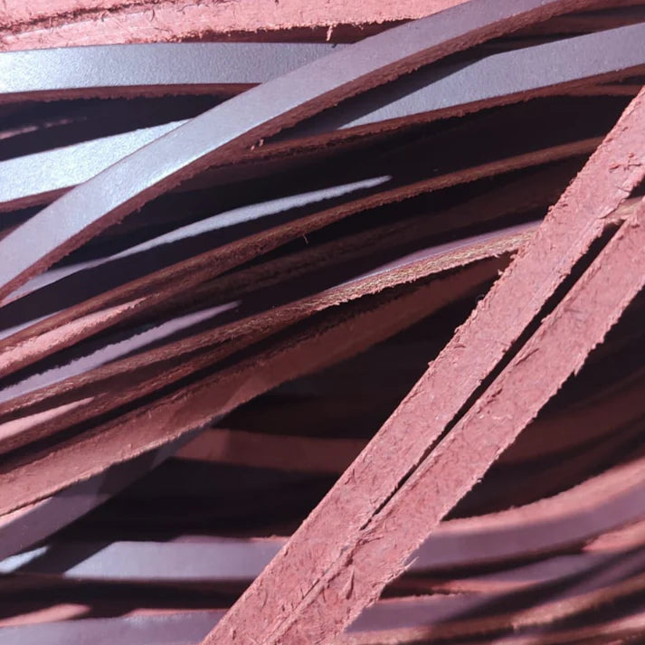 Roughstock Rosin Strapped AF Boot and Spur Ties. Close-up of brown leather strips stacked together